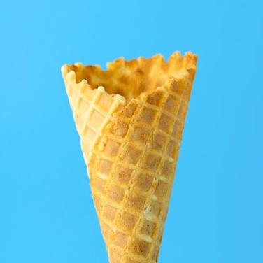 An empty ice cream cone on a blue background